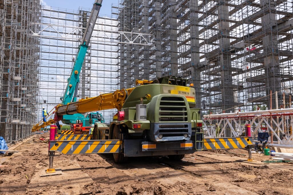 Heavy machinery and complex scaffolding at a major commercial construction site managed by Solid State Concrete.