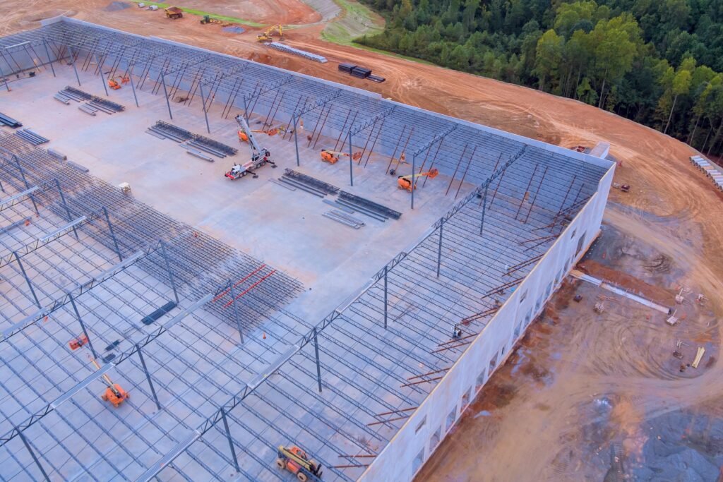 Aerial perspective of a massive industrial warehouse foundation and concrete slab in North Dakota.